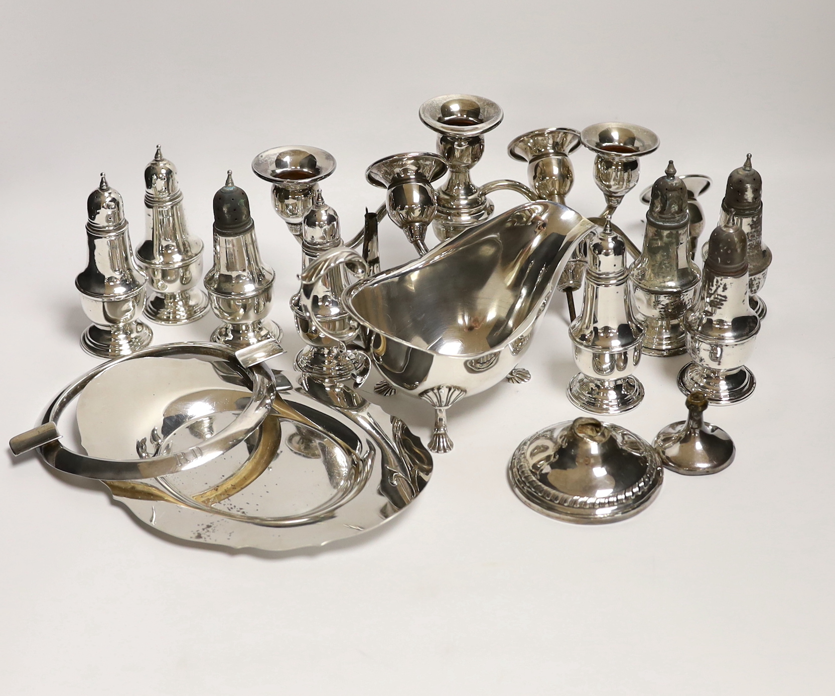 A quantity of assorted sterling or 800 standard white metal items including eight pepperettes, damaged pair of dwarf candelabra, sauceboat on stand etc.